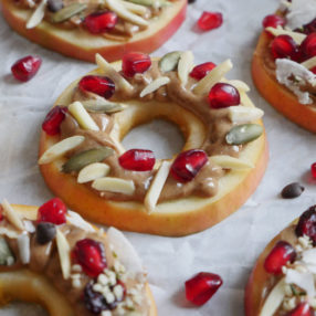 Holiday Apple Wreaths! Decorate apples with these toppings for a healthy holiday snack or dessert! Read the post to learn how to make this a fun event!! Recipe by Ashley of MyHeartBeets.com